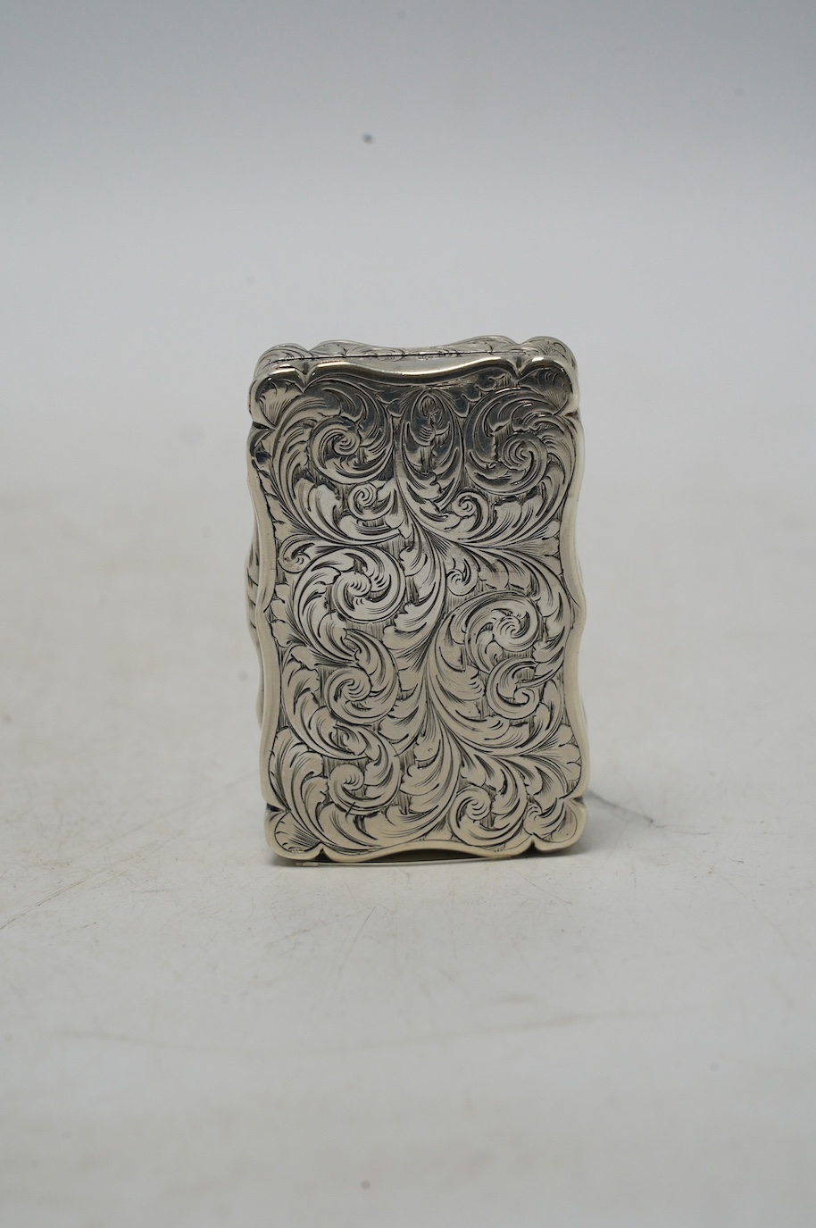 A Victorian engraved snuff box, by George Unite, Birmingham, 1853, 61mm. Condition - fair